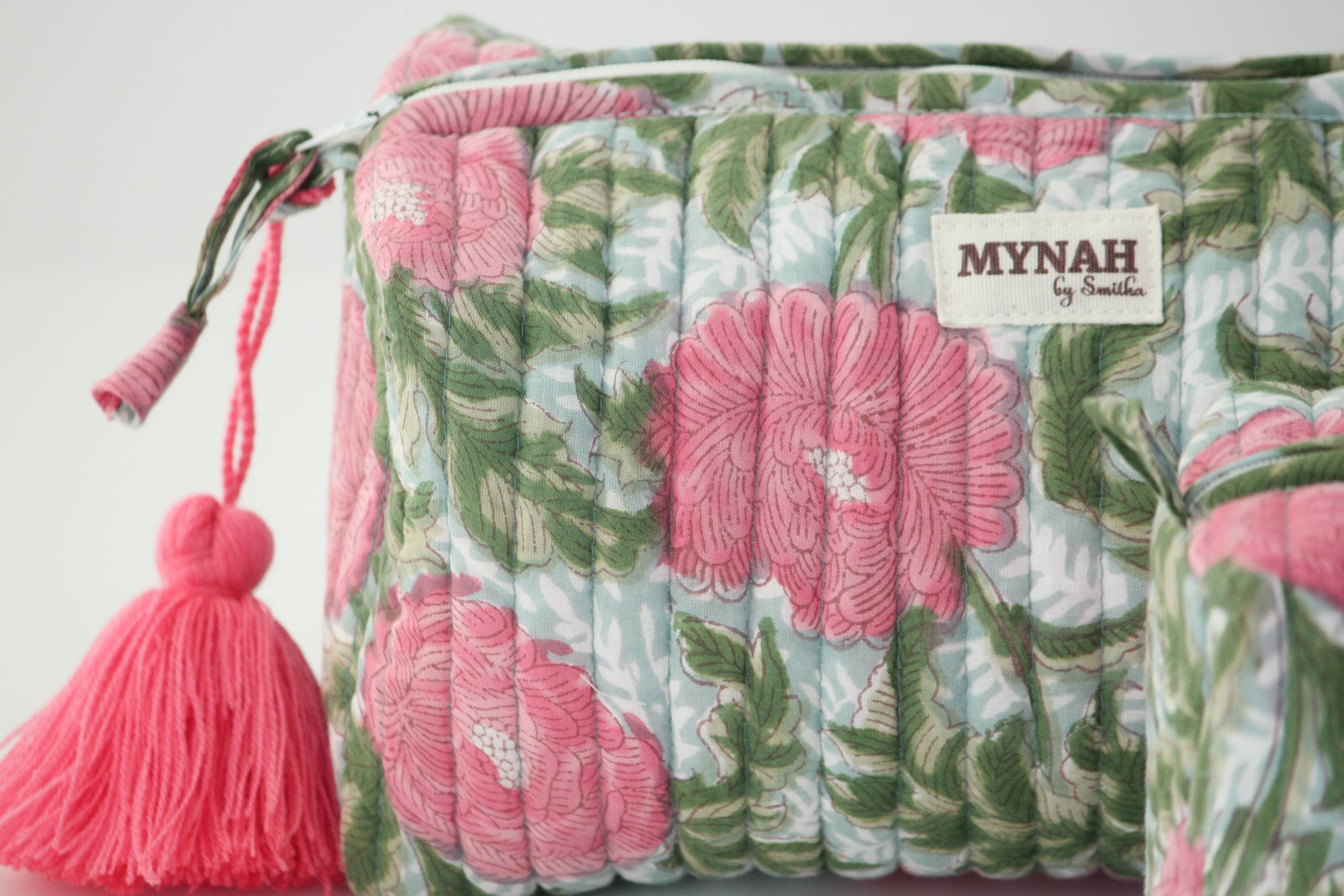 A single green leaf against a white background.