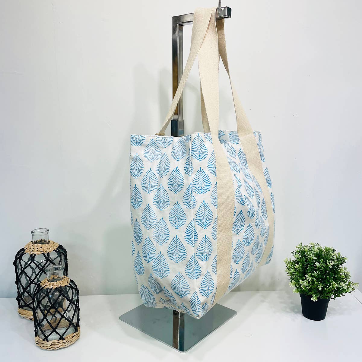 A single green leaf against a white background.