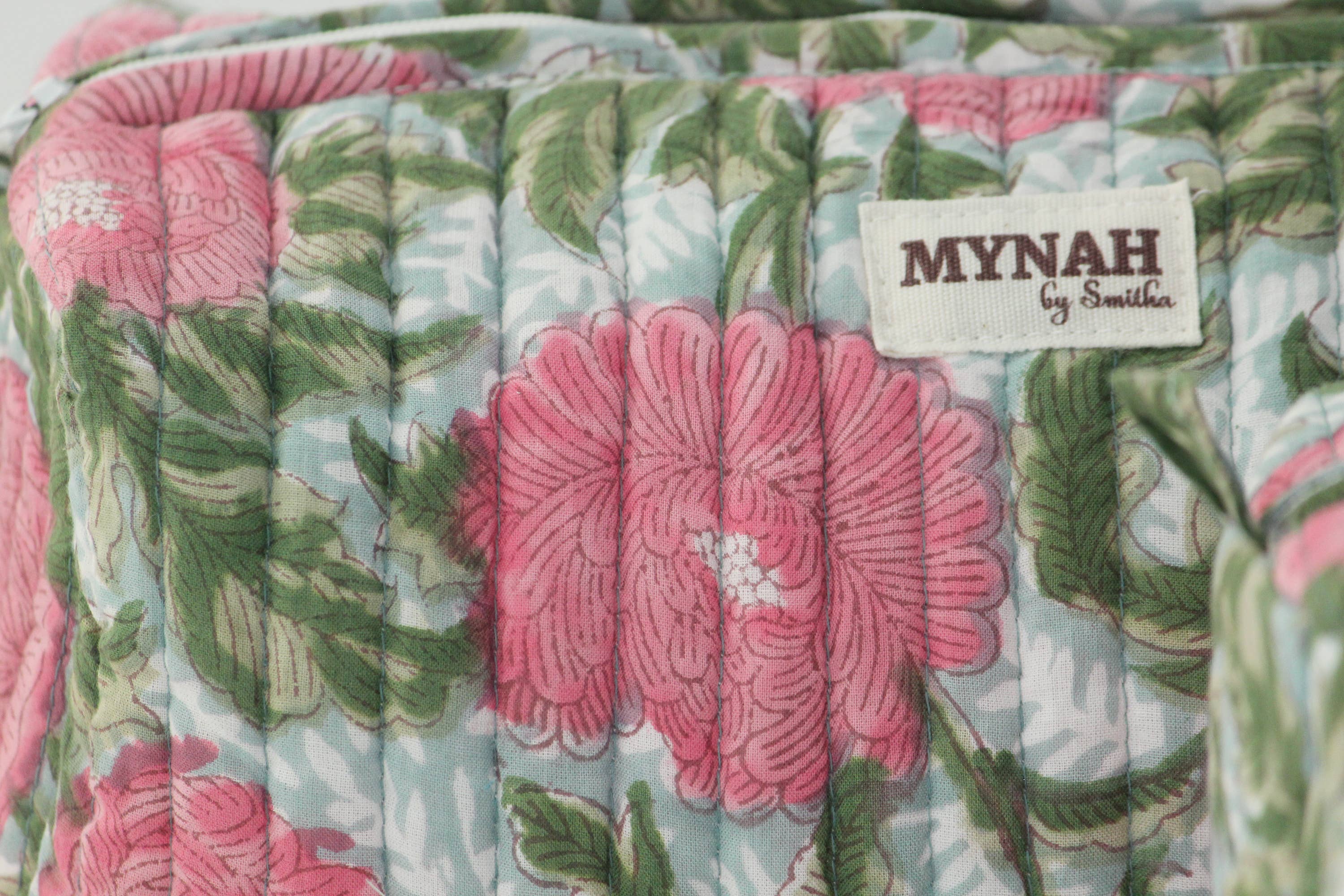 A single green leaf against a white background.