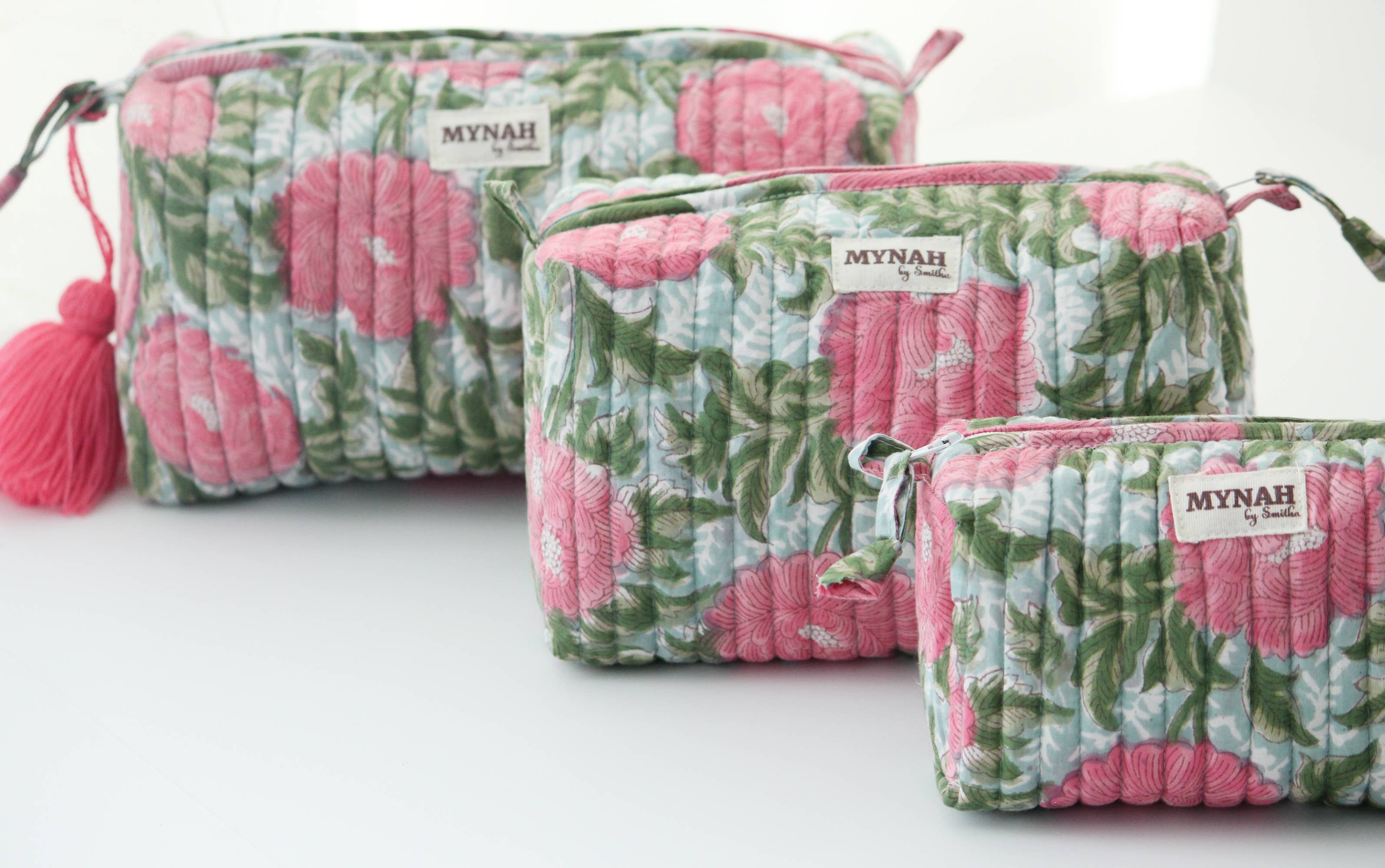 A single green leaf against a white background.